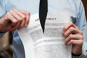 a company employee tearing up his paper contract after having performed a breach of employment contract by selling client information