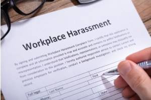 Someone filling out a harassment complaint because of a hostile work environment