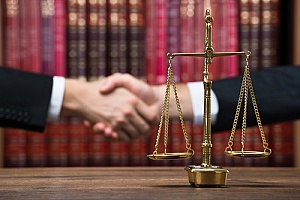 a defendant shaking hands with an attorney after researching how to select a criminal defense attorney