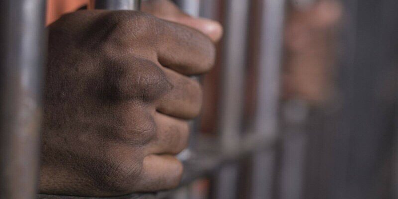 african american man behind bars