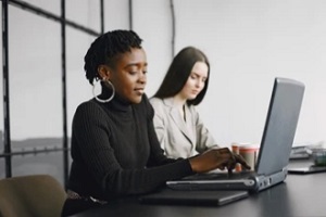 black women working insecurely in the office