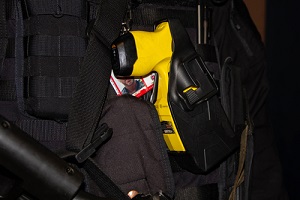 taser in a holster on a black british police uniform