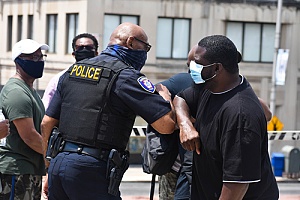 a man and police officer in a confrontation 