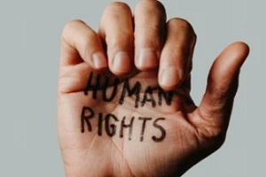 human rights written in closing hand