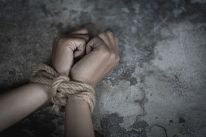 Hands tied by rope