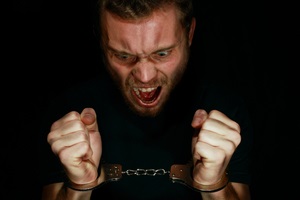 man in handcuffs angry