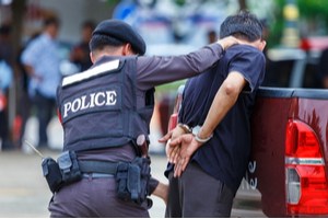 A police officer arresting a man
