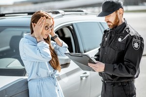 A woman with a car detained by a male police officer