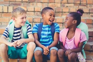 Three kids of different races in the school park representing individual rights